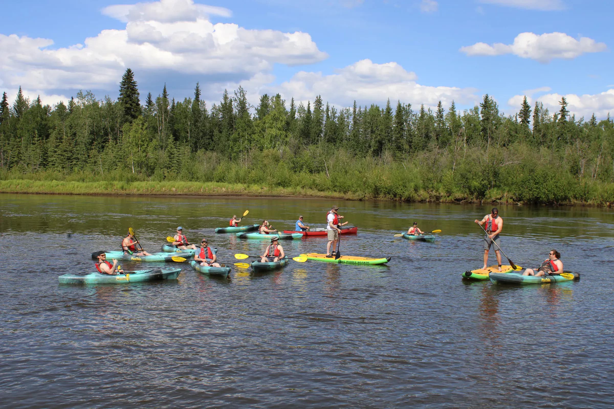 Canoe and kayak float on the Chena River in Fairbanks Alaska